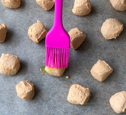 brushing tofu balls with olive oil